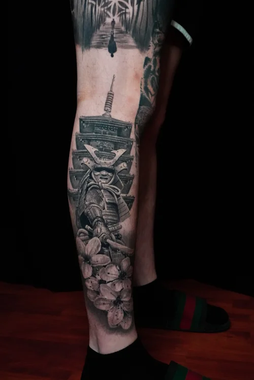 Nelson Aviles black and grey realism tattoo of a Buddhist figure with dove and lotus