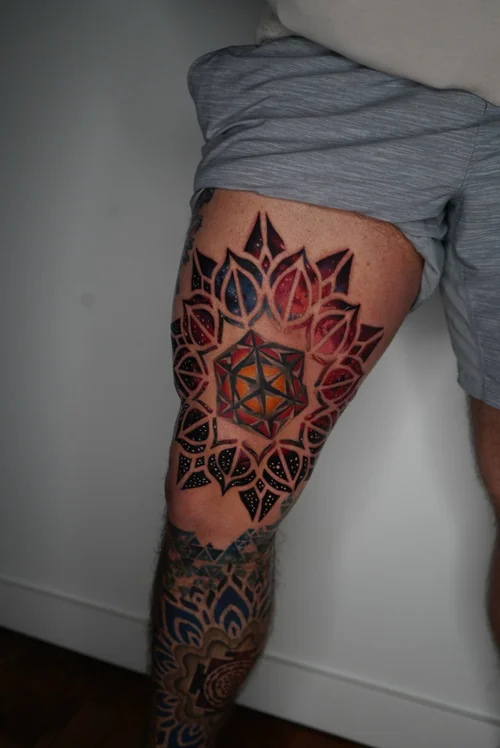 Nelson-Aviles-geometric-forearm-tattoo-with-blue-and-pink-mandala-elements