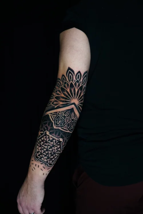 Nelson-Aviles-geometric-tattoo-sleeve-with-pink-starburst-and-mandala-pattern