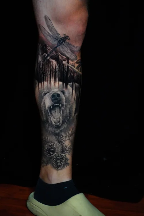 Nelson-Aviles-surrealistic-sleeve-tattoo-featuring-a-roaring-bear-and-Native-American-elements