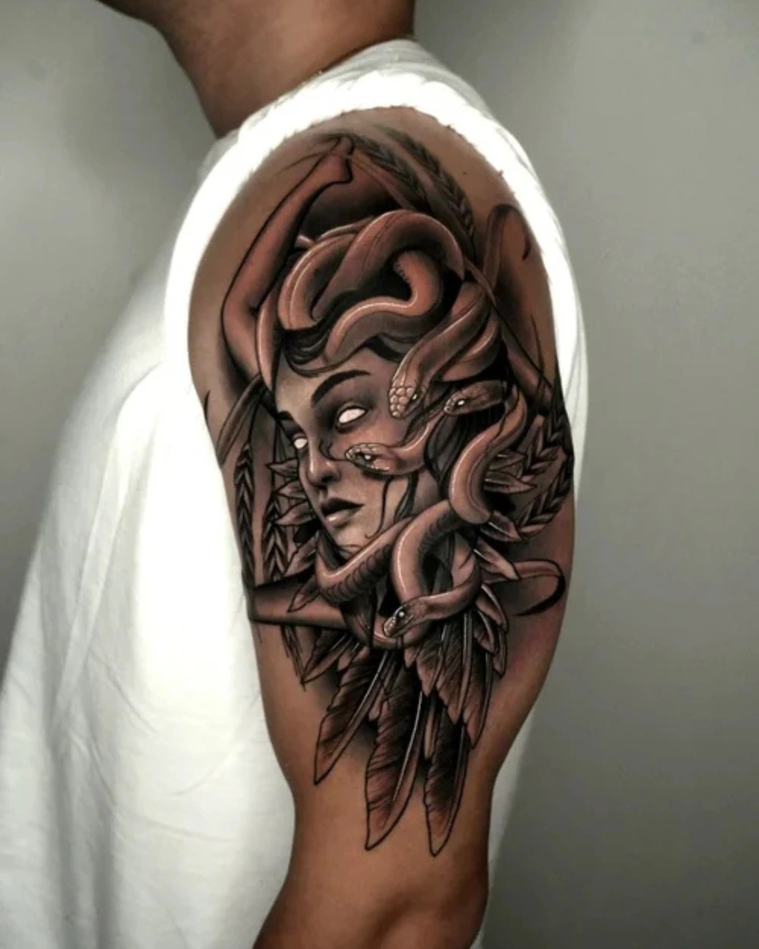Surrealism-tattoo-of-Medusa-with-serpents-and-stylized-feathers-representing-myth-and-inner-power