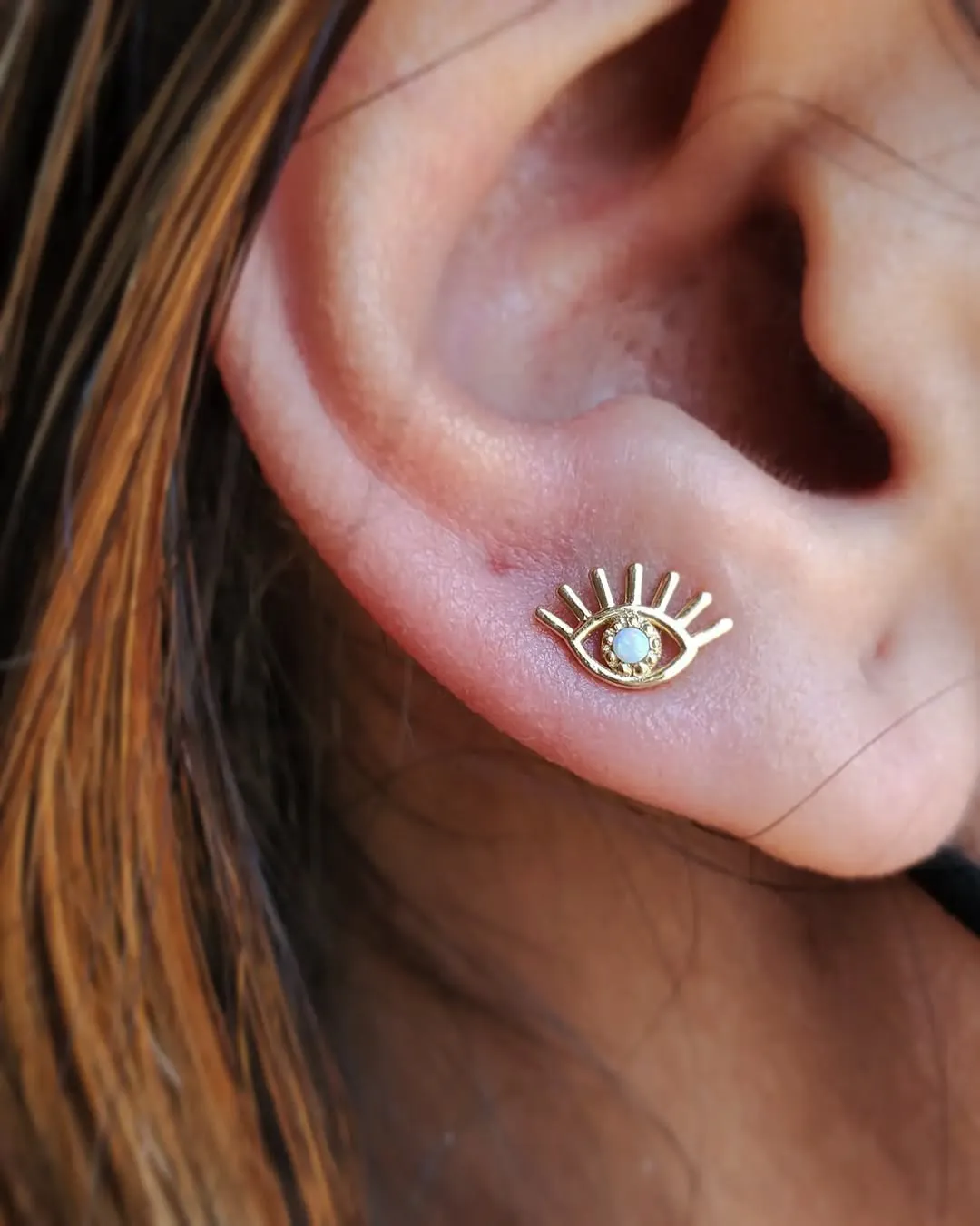 body piercing tragus evil eye gold ear piercing chicago studio